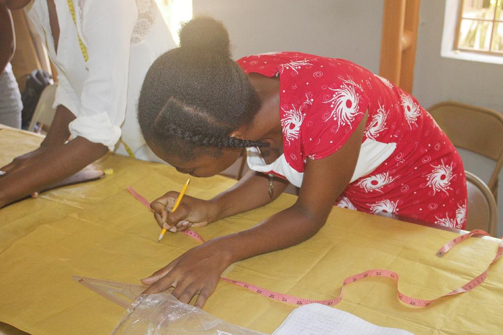 Students working on sewing machines in tailoring workshop